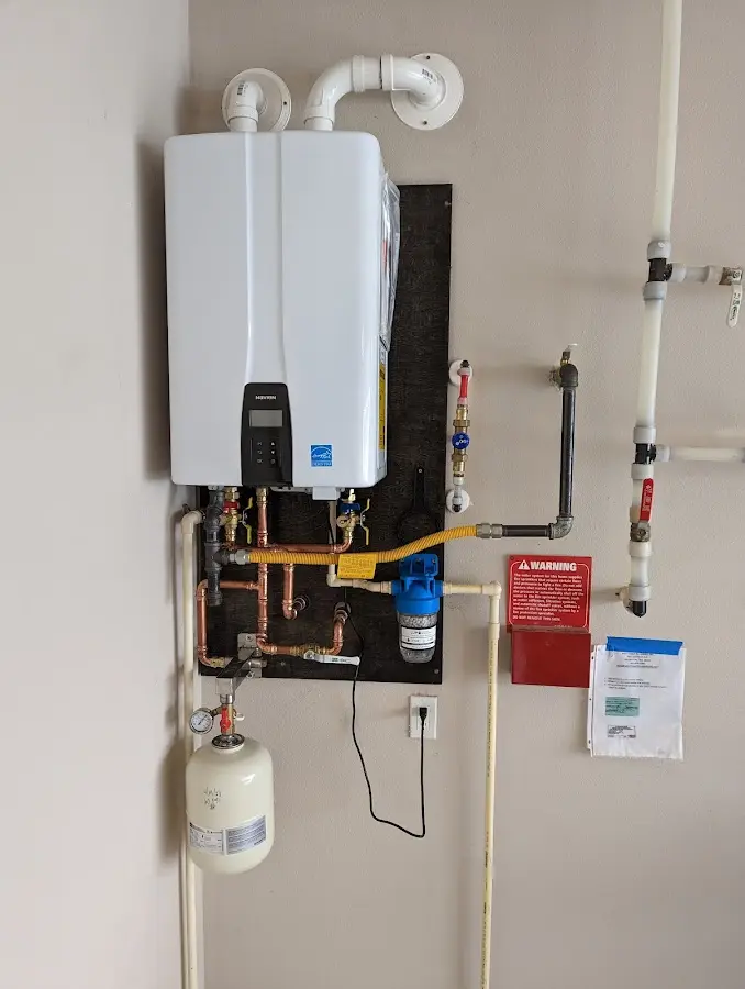 Professional plumber installing copper piping in a Cottrellville home